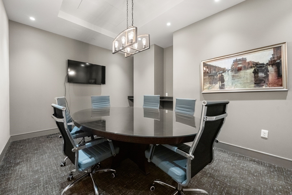 121-127 Portland Street, Unit 307 Boston, MA 02114 - Photo 20 of 27 a view of a dining room with furniture and chandelier
