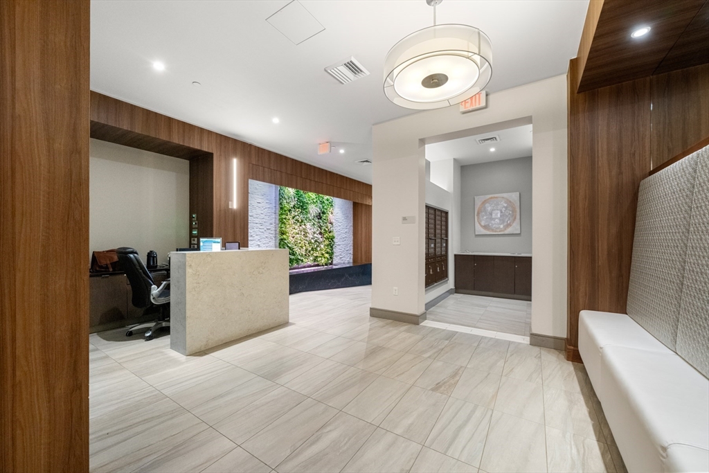121-127 Portland Street, Unit 307 Boston, MA 02114 - Photo 24 of 27 a view of a livingroom with furniture and windows