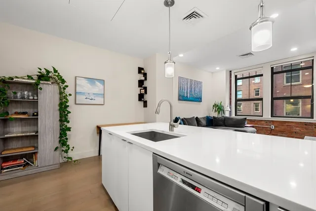 a kitchen that has a sink a stove and a table in it