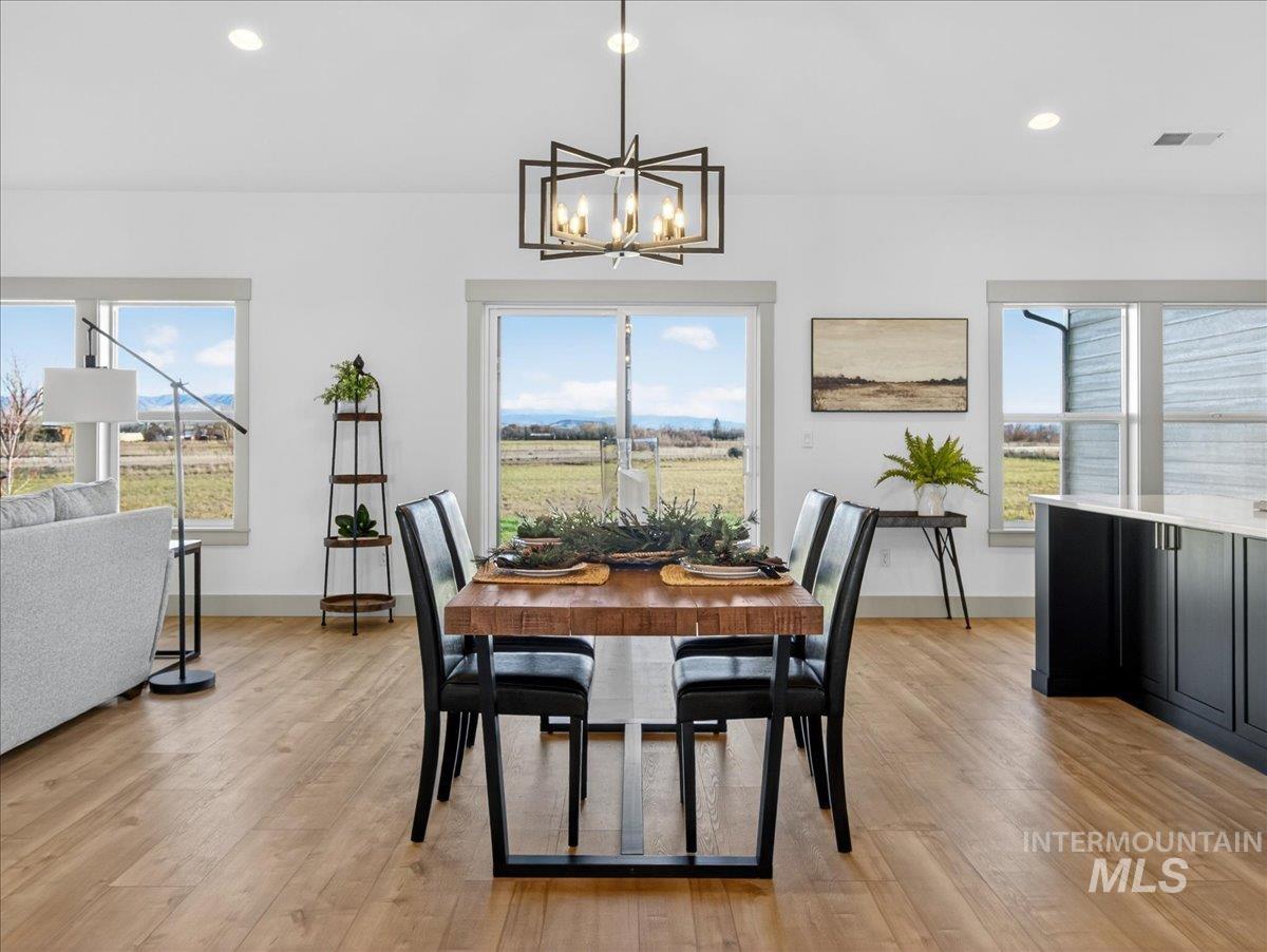 2240 Little Rock Road Emmett, ID 83617 - Photo 17 of 50 Dining space with light wood-style floors, recessed lighting, plenty of natural light, and a chandelier
