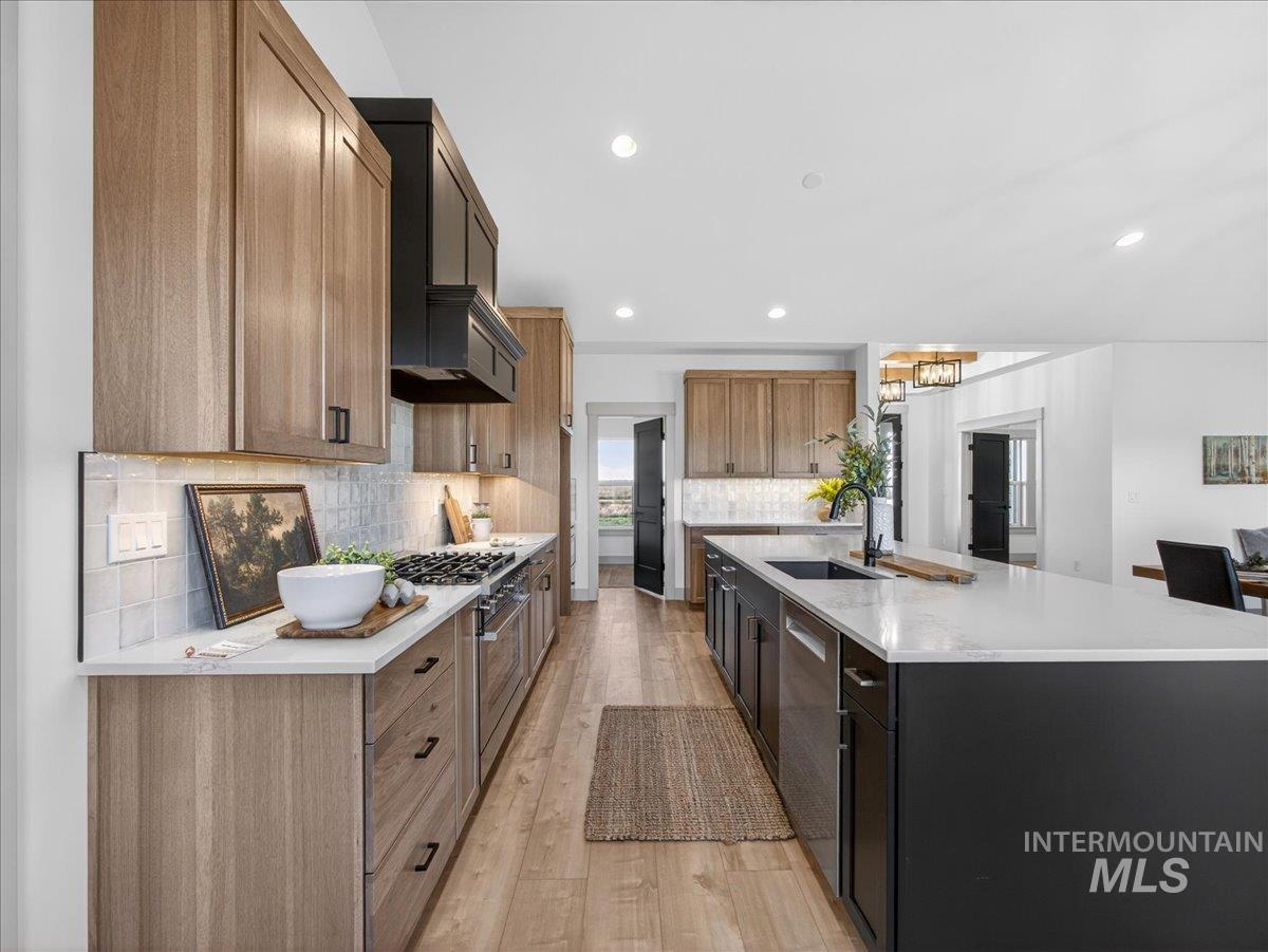 2240 Little Rock Road Emmett, ID 83617 - Photo 20 of 50 Kitchen with a spacious island, light wood-type flooring, light stone counters, recessed lighting, and stainless steel appliances