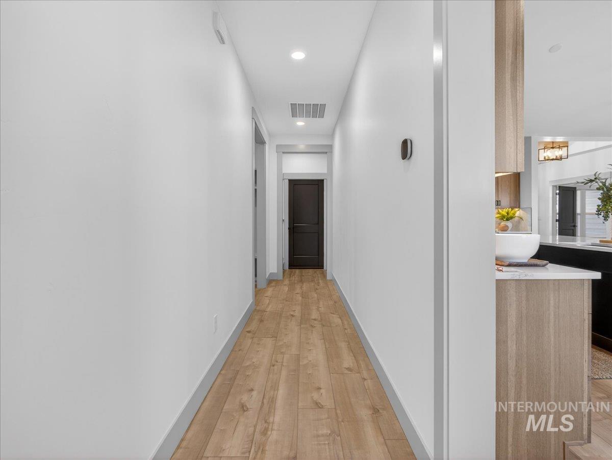 2240 Little Rock Road Emmett, ID 83617 - Photo 33 of 50 Hallway with light wood finished floors, recessed lighting, and a chandelier