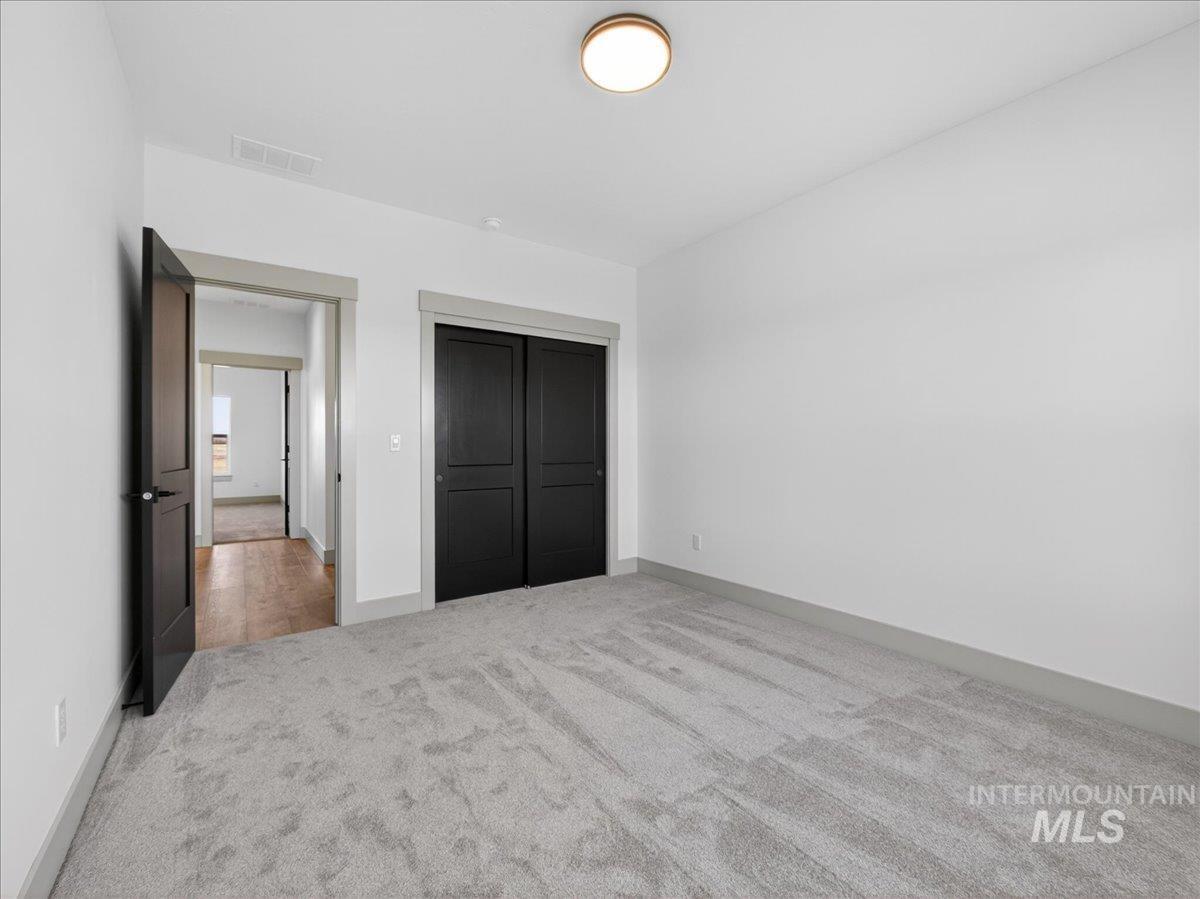 2240 Little Rock Road Emmett, ID 83617 - Photo 39 of 50 Unfurnished bedroom featuring light colored carpet and a closet