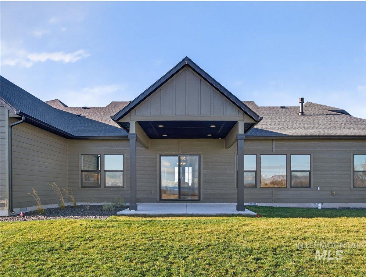 2240 Little Rock Road Emmett, ID 83617 - Photo 45 of 50 Rear view of house with a patio, a lawn, and a shingled roof