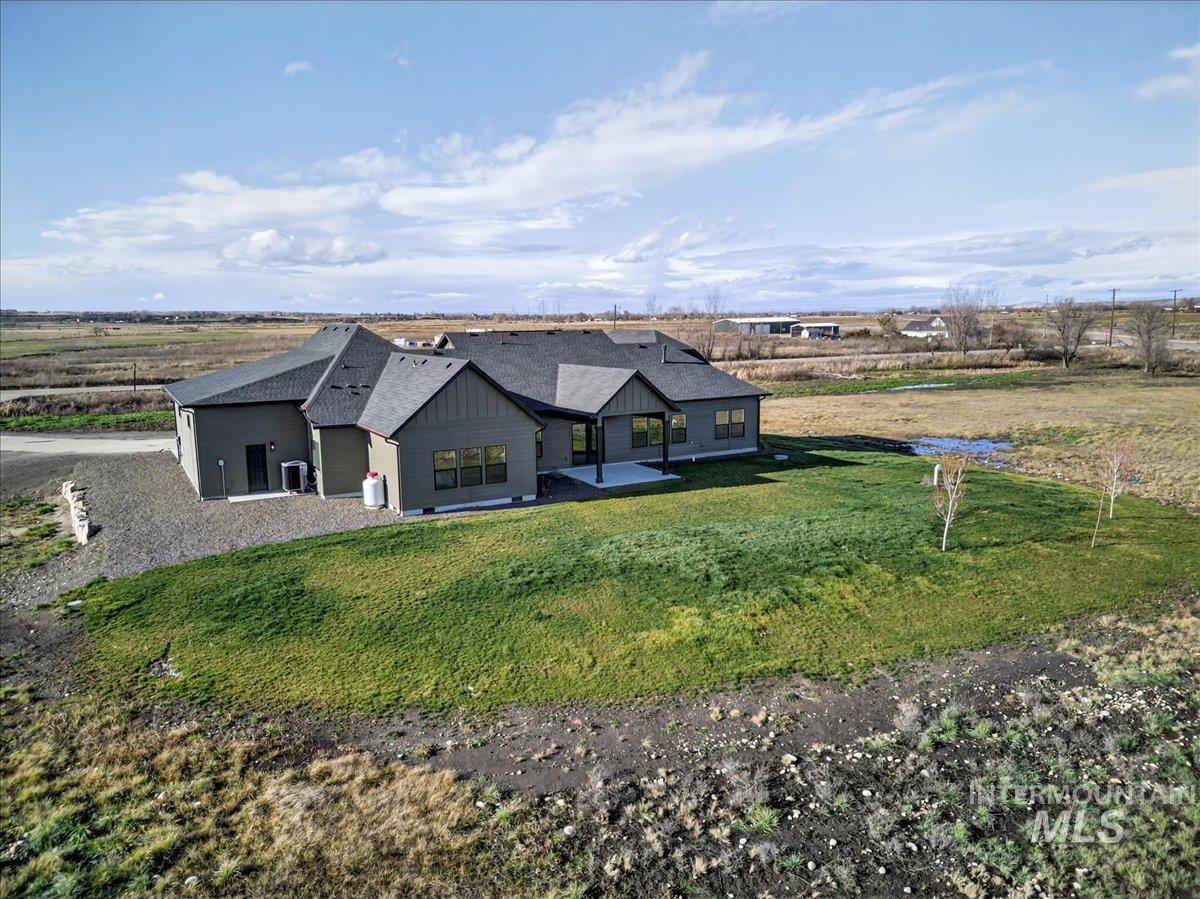 2240 Little Rock Road Emmett, ID 83617 - Photo 46 of 50 View of front of house with a patio area, a front lawn, a shingled roof, and board and batten siding