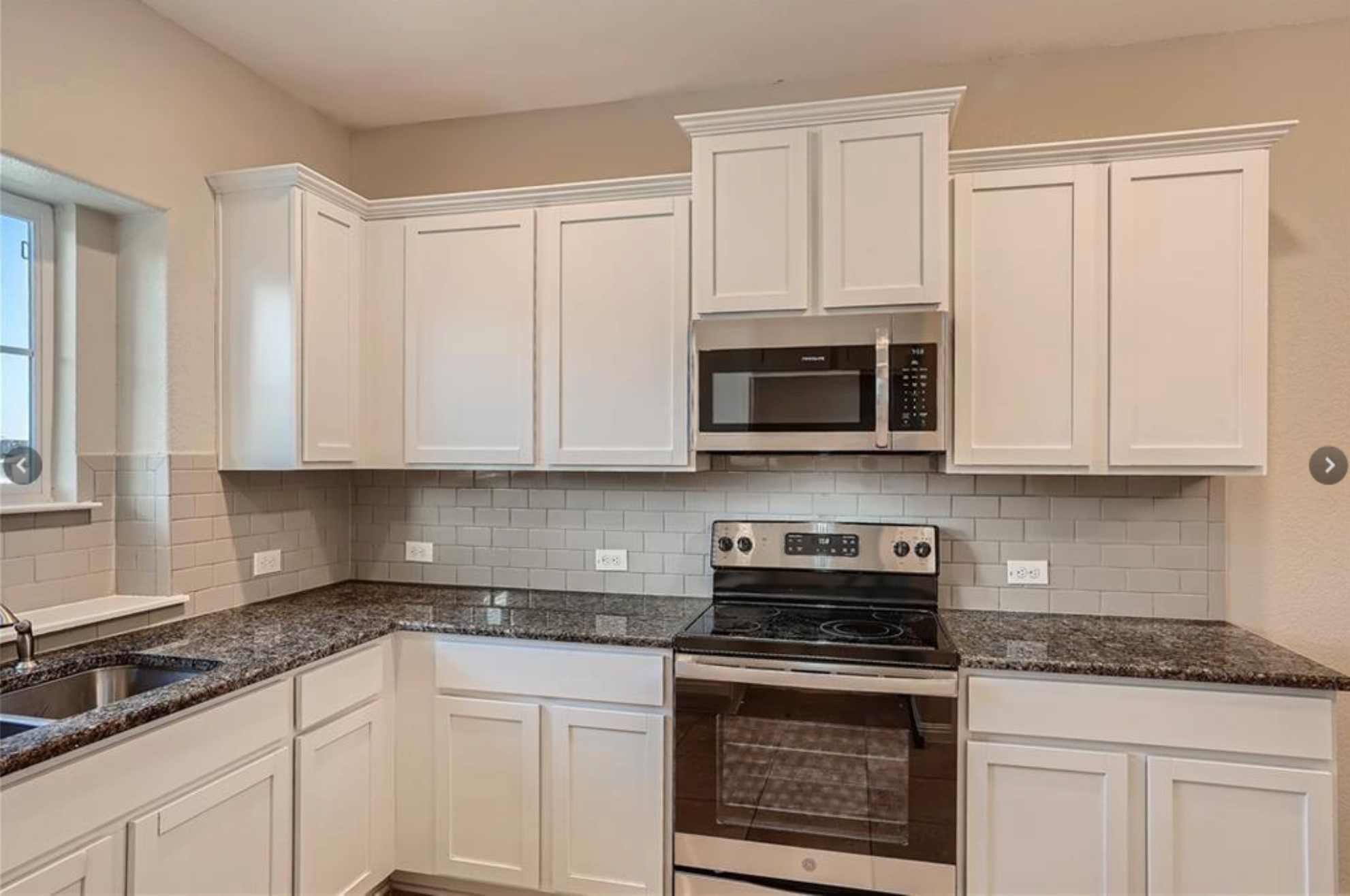 304 Cane River Road Pflugerville, TX 78660 - Photo 7 of 31 Granite counters and stainless appliances define this well-appointed, functional kitchen.