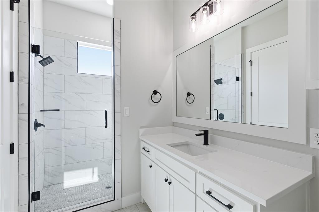713 Anne Road Van Alstyne, TX 75495 - Photo 22 of 29 White vanity with a single basin sink, matte black faucet, and white countertop