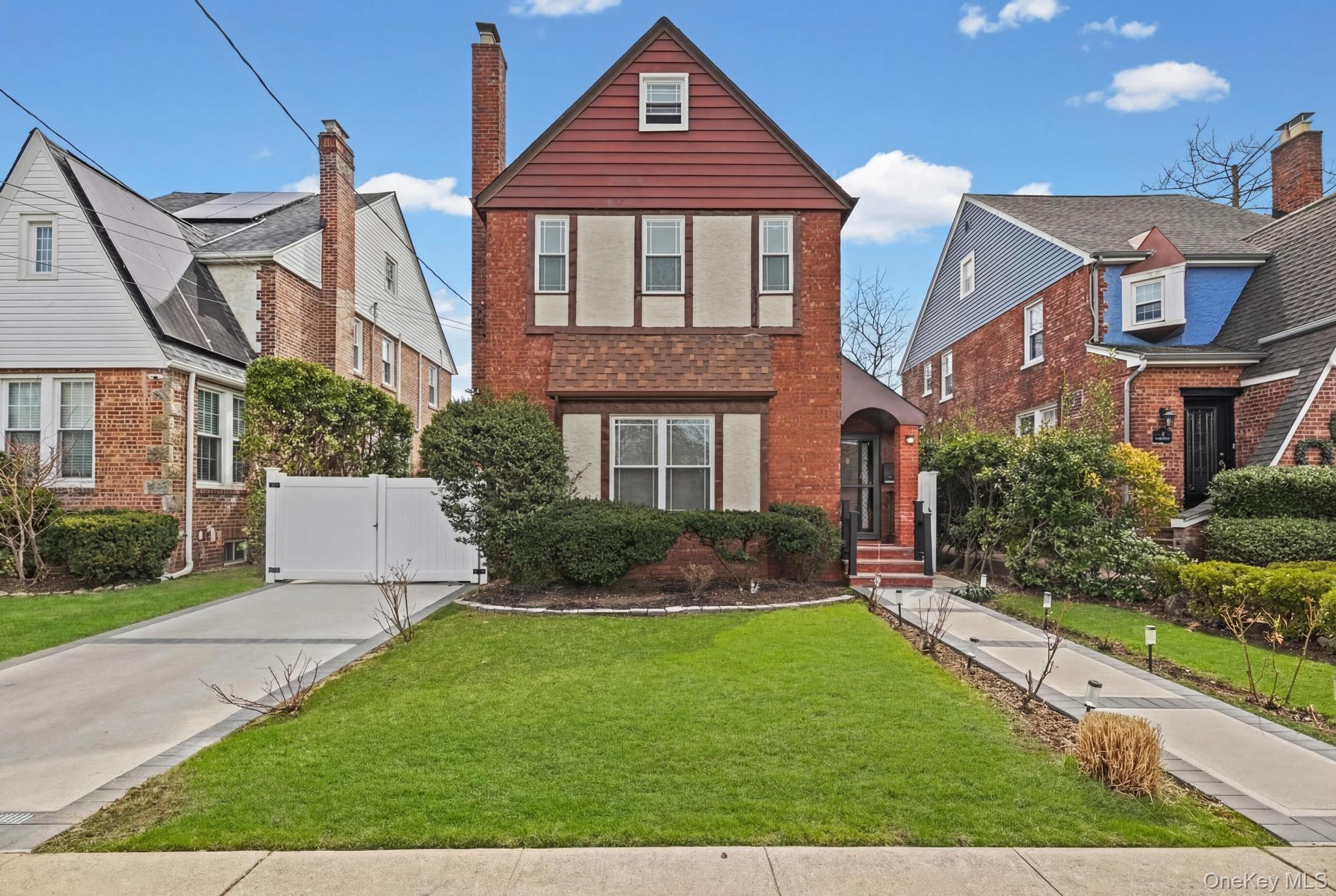 Tudor home featuring brick siding