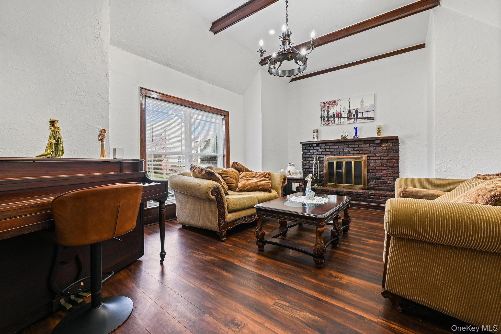 6 Dubonnet Road Valley Stream, NY 11581 - Photo 4 of 27 Living area with lofted ceiling, textured walls and Wood burning Fireplace