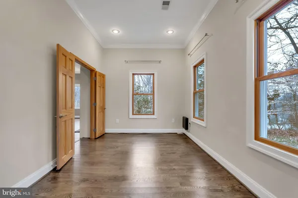 wooden floor in an empty room with a window
