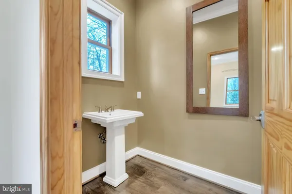 a bathroom with a sink a mirror and a window