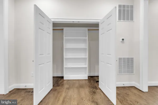 a view of a room with wooden floor and closet