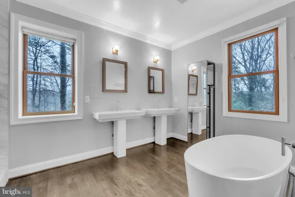 a spacious bathroom with a bathtub and a sink