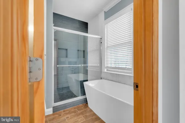 a bathroom with a bathtub and shower
