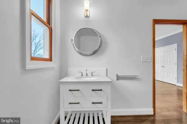 a bathroom with a sink a mirror and a toilet