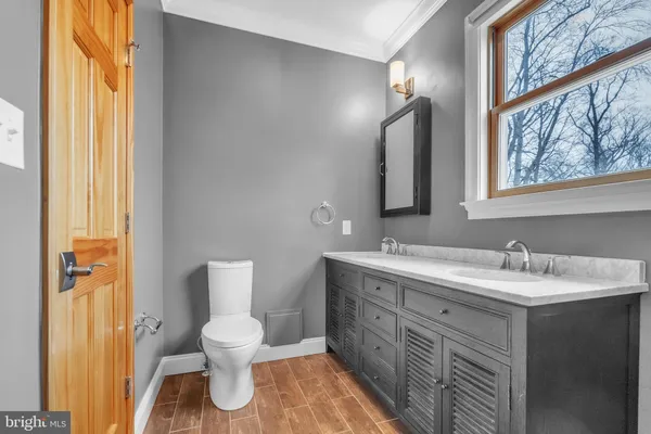 a bathroom with a toilet a sink and mirror