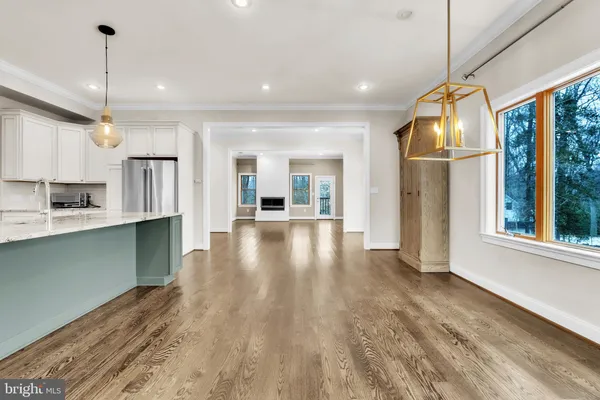 a view of a kitchen with wooden floor and a window
