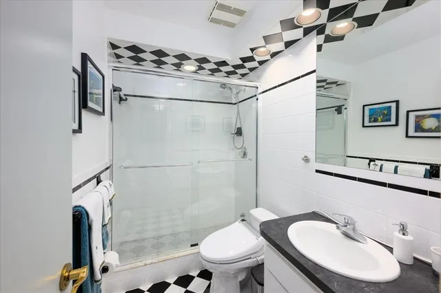 a bathroom with a sink toilet and shower