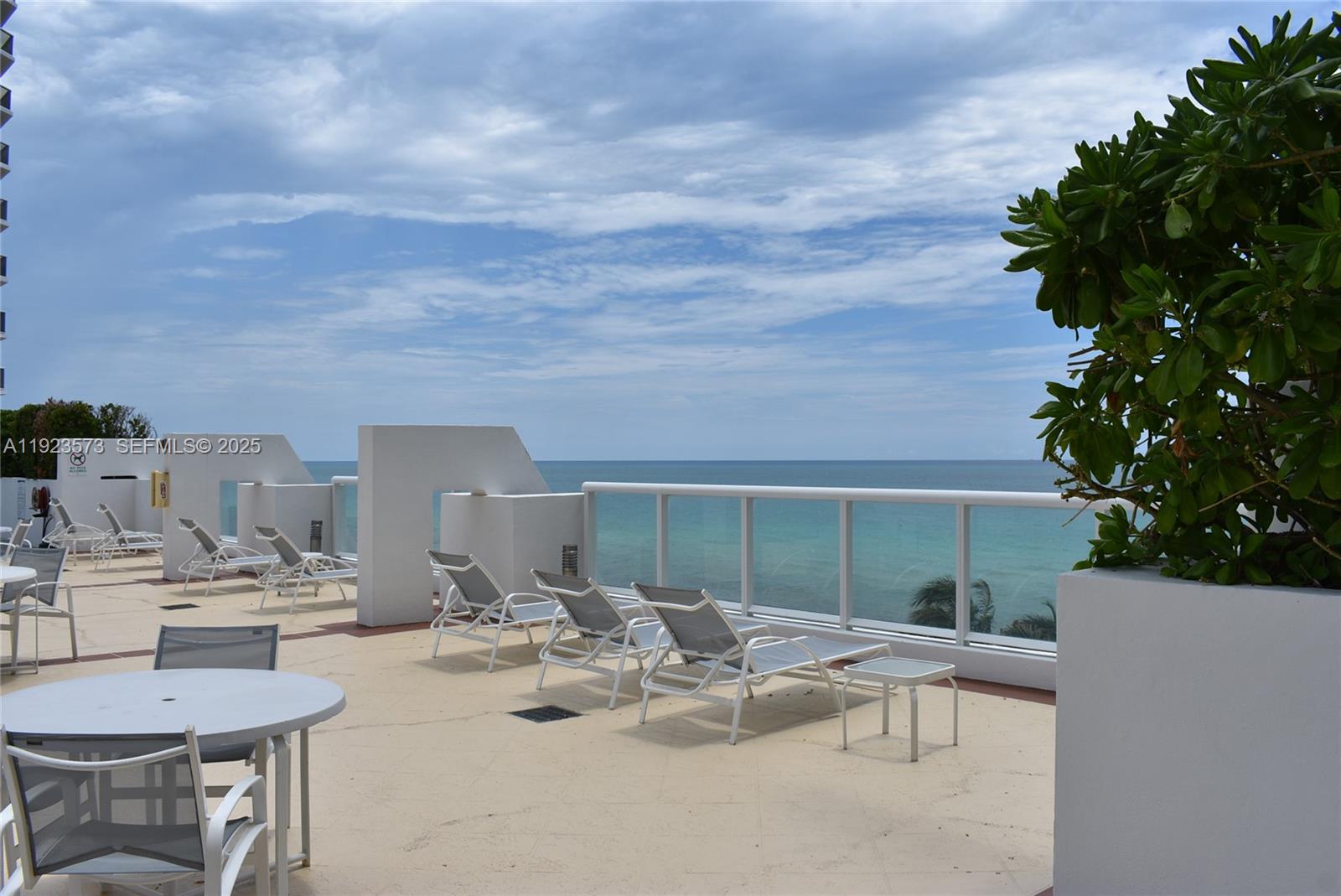 6365 Collins Avenue, Unit 3804 Miami Beach, FL 33141 - Photo 19 of 33 a view of a dinning table and chairs in the patio