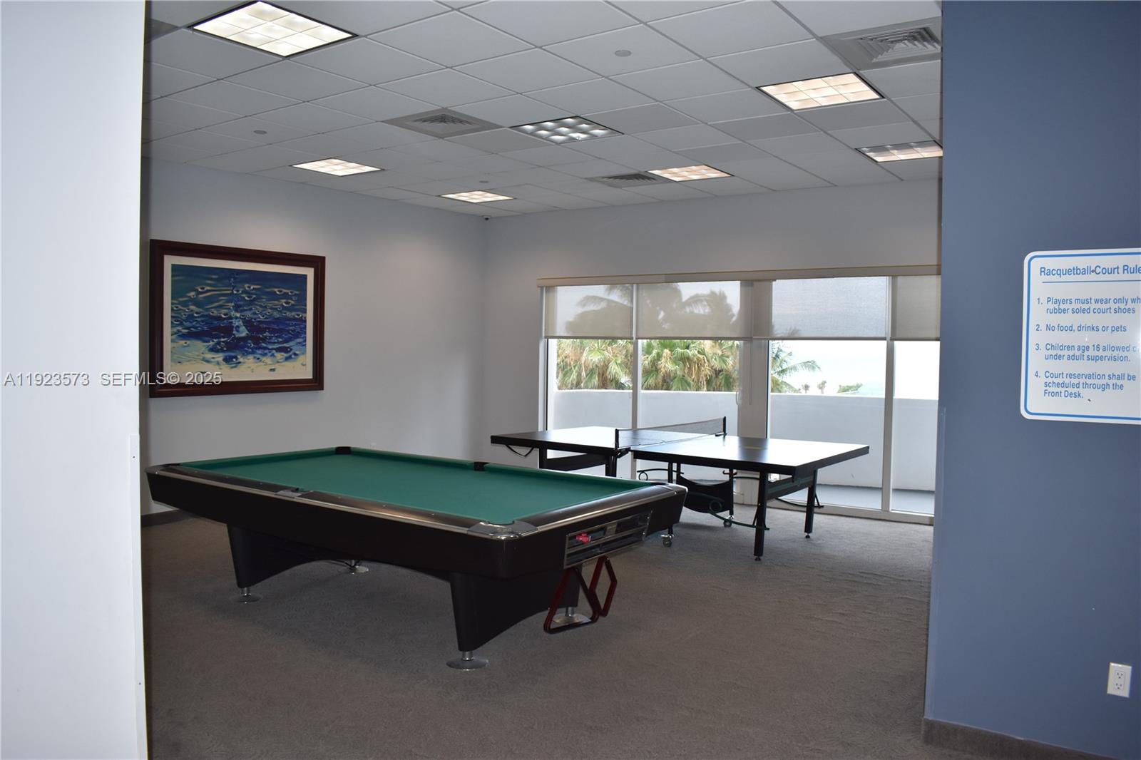 6365 Collins Avenue, Unit 3804 Miami Beach, FL 33141 - Photo 22 of 33 a room with pool table and windows