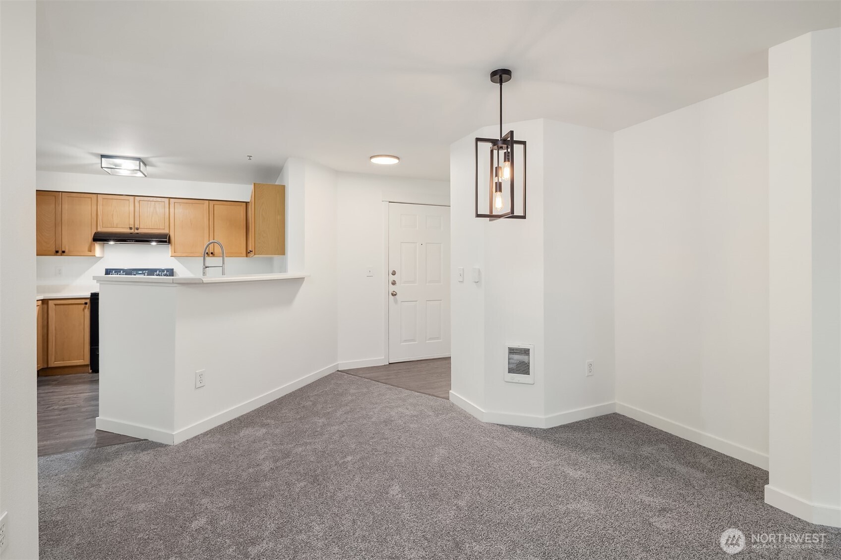 7711 Northeast 175th Street, Unit B210 Kenmore, WA 98028 - Photo 11 of 25 an empty room with a cabinet and a view of kitchen