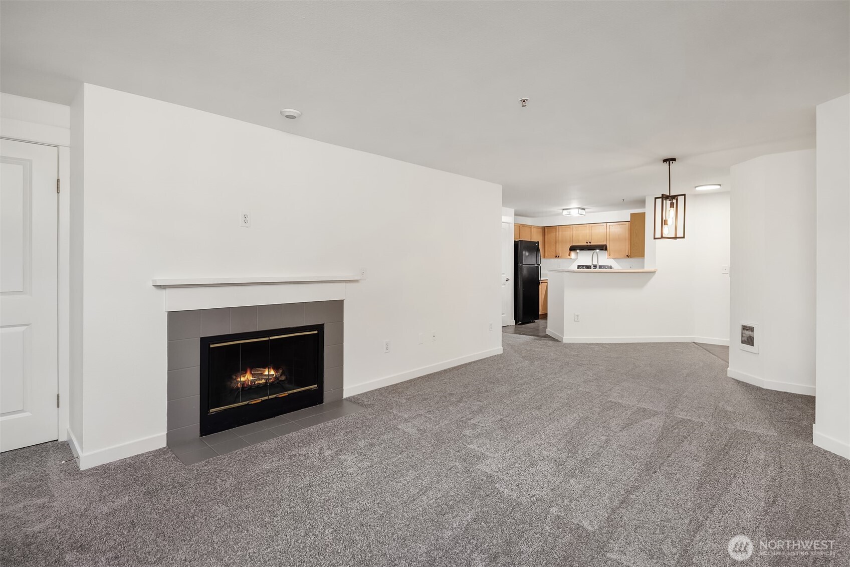 7711 Northeast 175th Street, Unit B210 Kenmore, WA 98028 - Photo 12 of 25 a view of empty room with a fireplace
