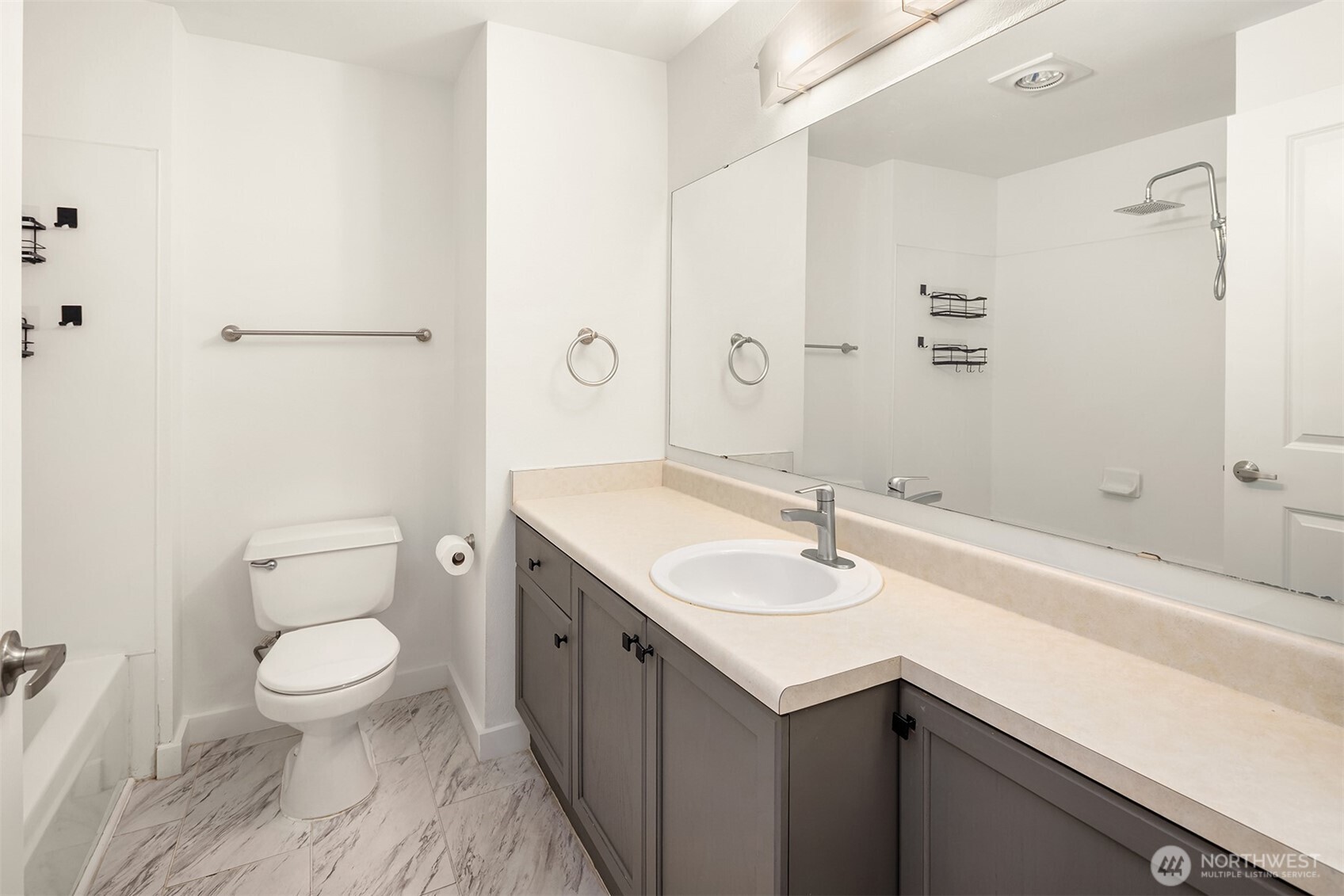 7711 Northeast 175th Street, Unit B210 Kenmore, WA 98028 - Photo 16 of 25 a bathroom with a sink a toilet and shower