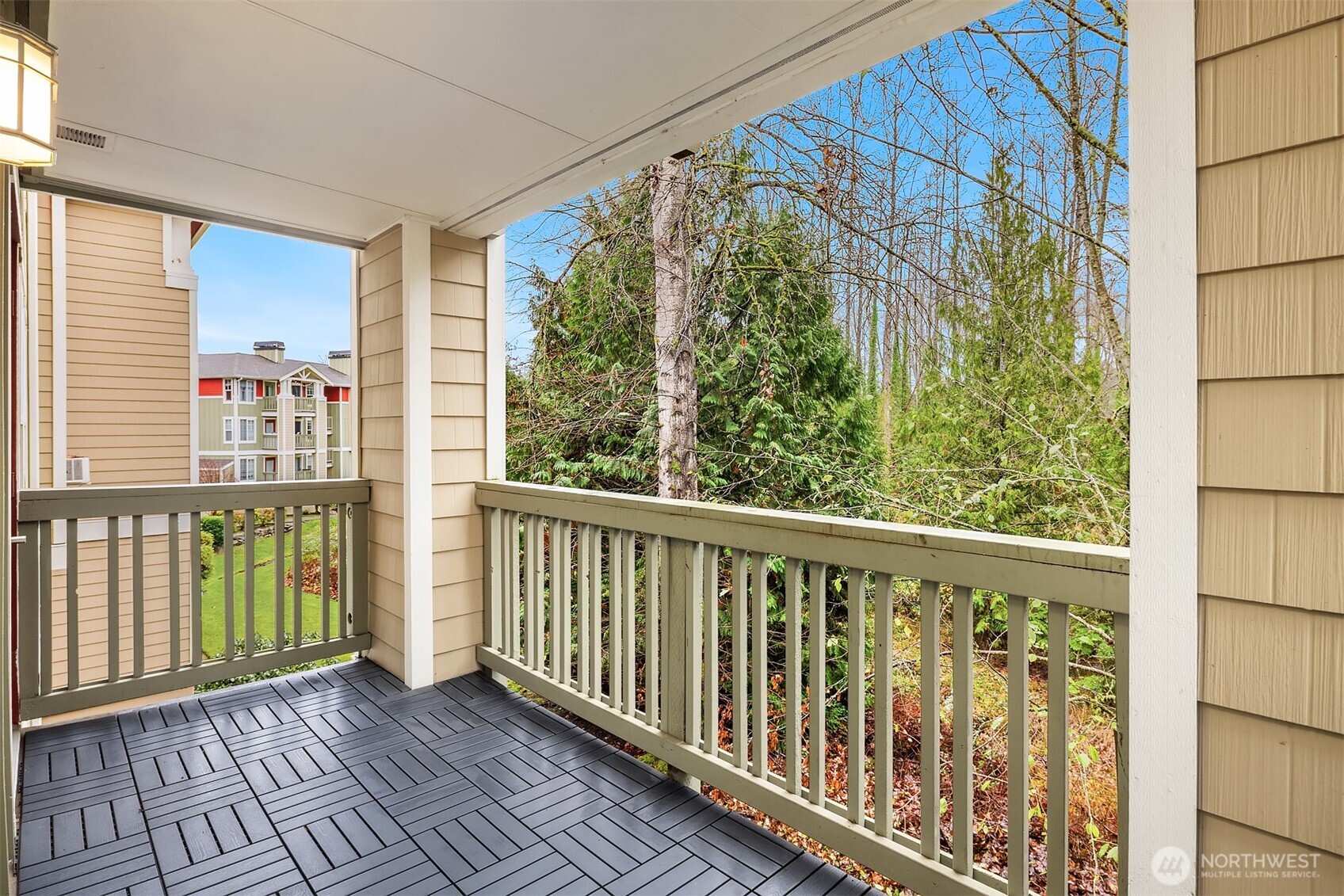 7711 Northeast 175th Street, Unit B210 Kenmore, WA 98028 - Photo 19 of 25 a view of a balcony with wooden floor