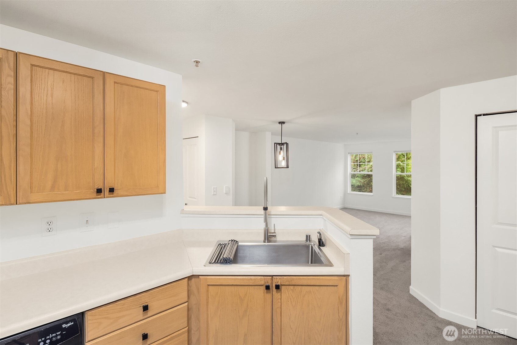 7711 Northeast 175th Street, Unit B210 Kenmore, WA 98028 - Photo 5 of 25 a kitchen with stainless steel appliances granite countertop a sink and a white cabinets