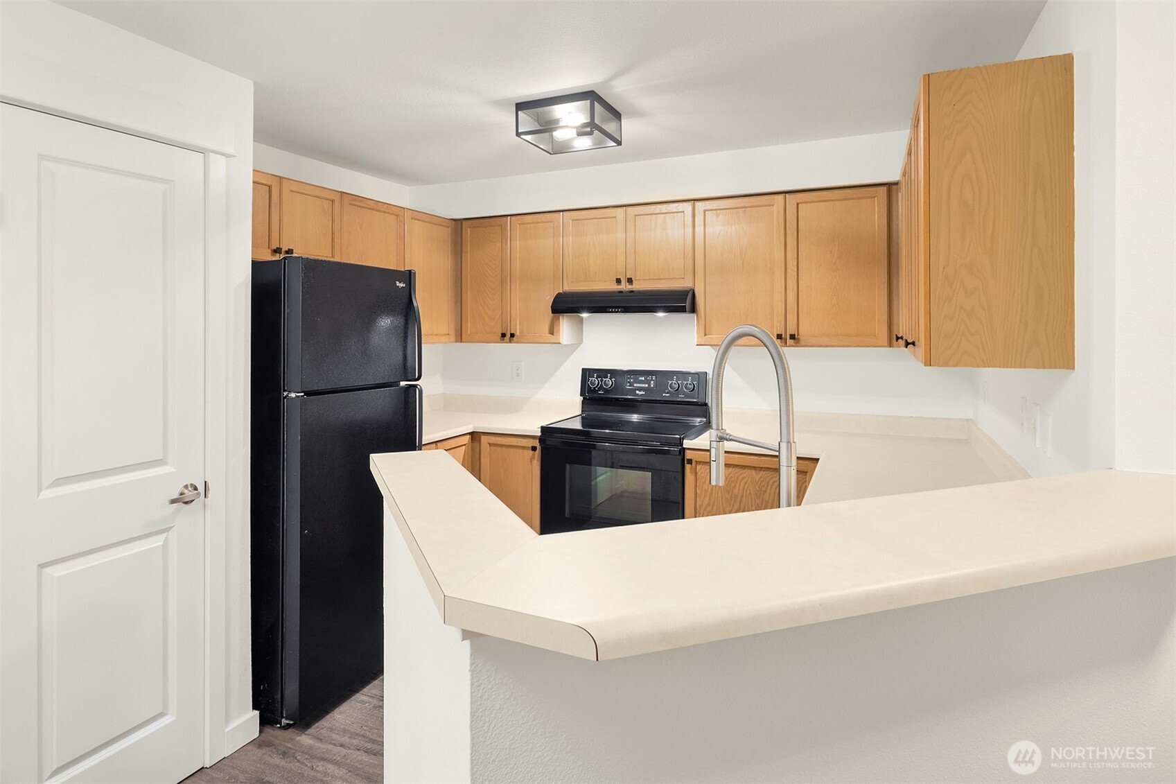 7711 Northeast 175th Street, Unit B210 Kenmore, WA 98028 - Photo 6 of 25 a kitchen with stainless steel appliances a refrigerator and a stove