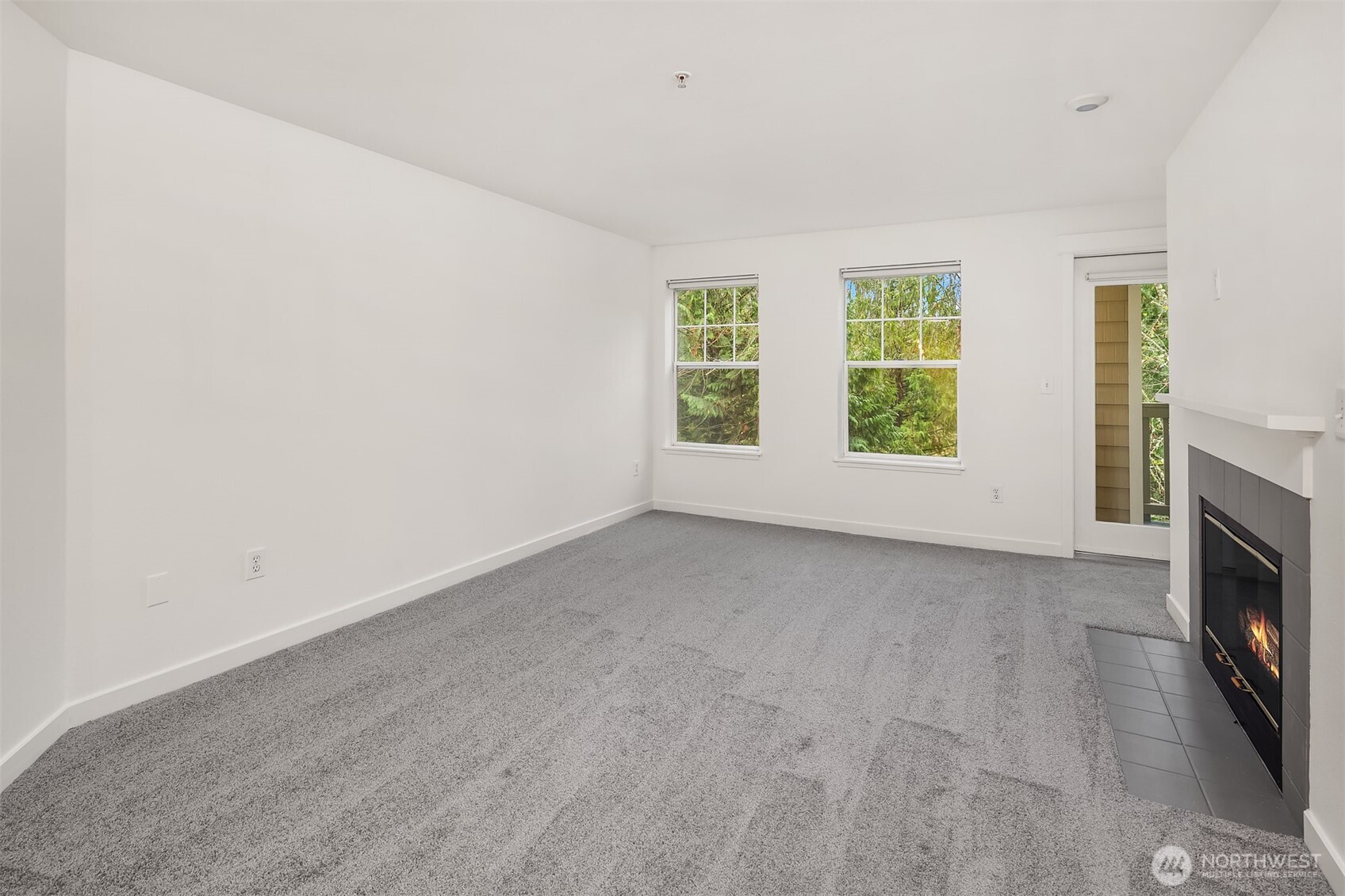 7711 Northeast 175th Street, Unit B210 Kenmore, WA 98028 - Photo 9 of 25 an empty room with windows and fireplace
