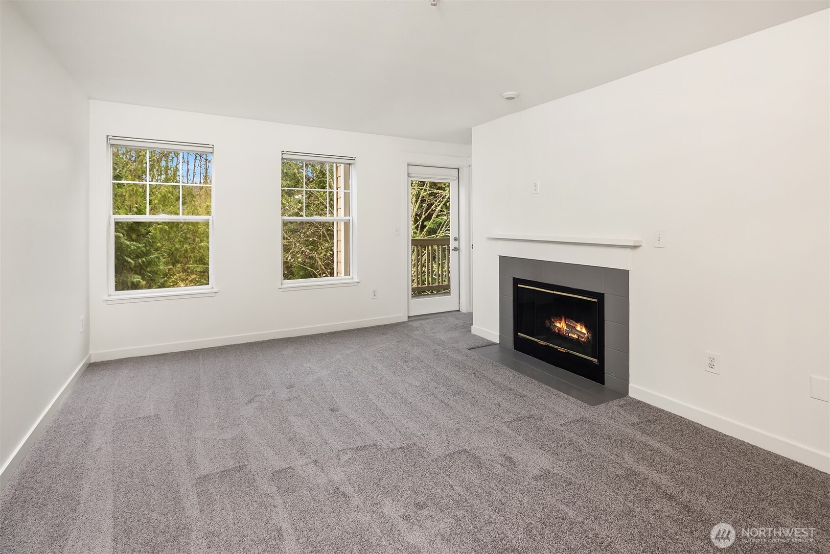 7711 Northeast 175th Street, Unit B210 Kenmore, WA 98028 - Photo 10 of 25 an empty room with windows and fireplace