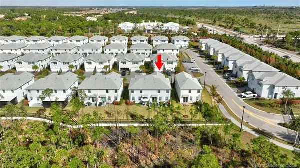 an aerial view of residential houses with outdoor space and street view