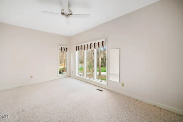 an empty room with a empty space and windows