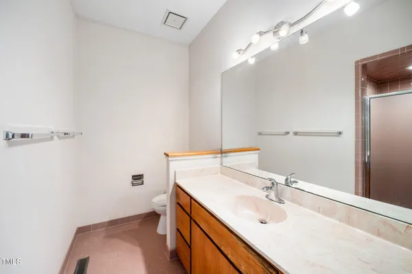 a bathroom with a sink a toilet and mirror