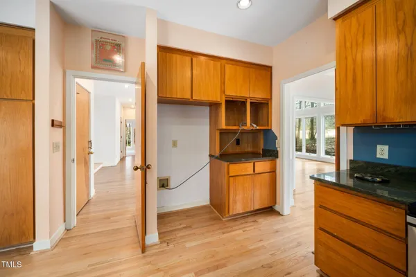 a kitchen with a refrigerator and a stove top oven