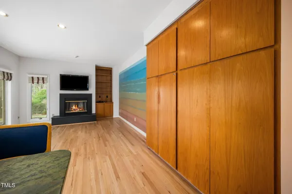 a view of a livingroom with a fireplace and window