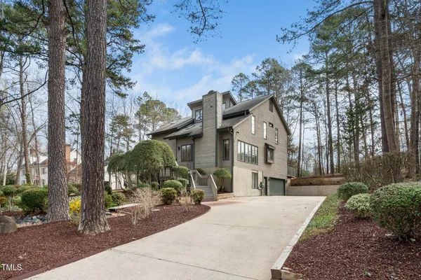 a front view of a house with a yard and fountain