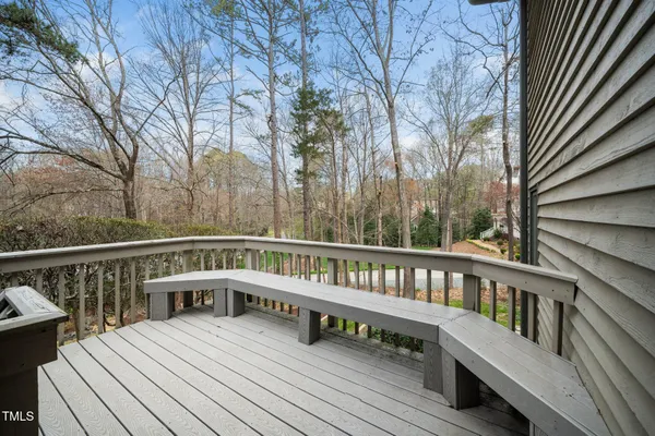 a view of a roof deck with wooden floor and fence