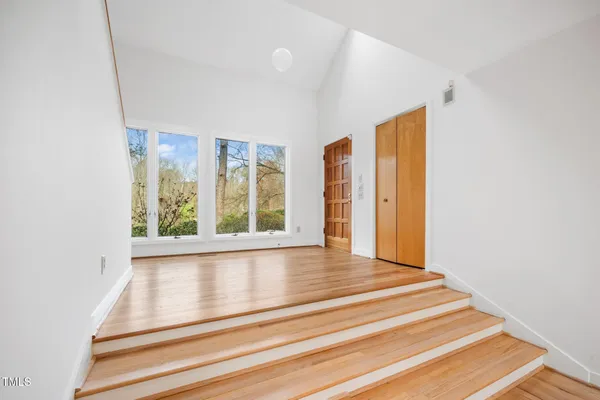 a view of an entryway with wooden floor