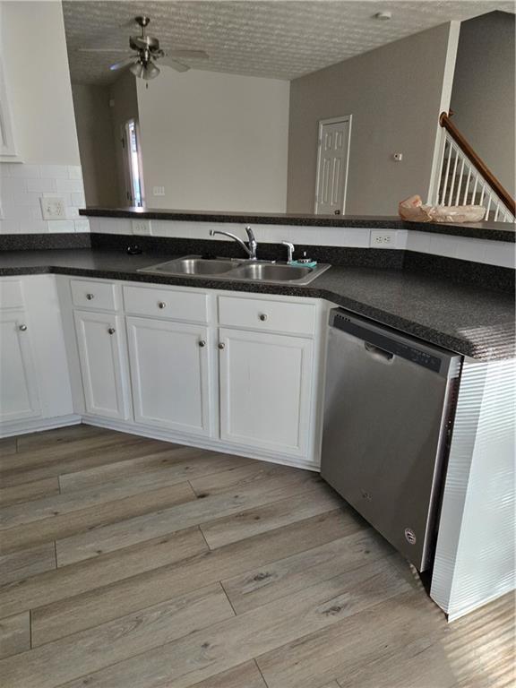 240 Ridge Mill Drive Acworth, GA 30102 - Photo 5 of 22 a kitchen with granite countertop a sink and cabinets