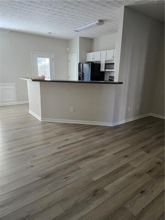 240 Ridge Mill Drive Acworth, GA 30102 - Photo 6 of 22 a view of a kitchen with kitchen island wooden floor and electronic appliances