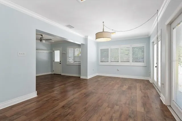 a view of an empty room with wooden floor