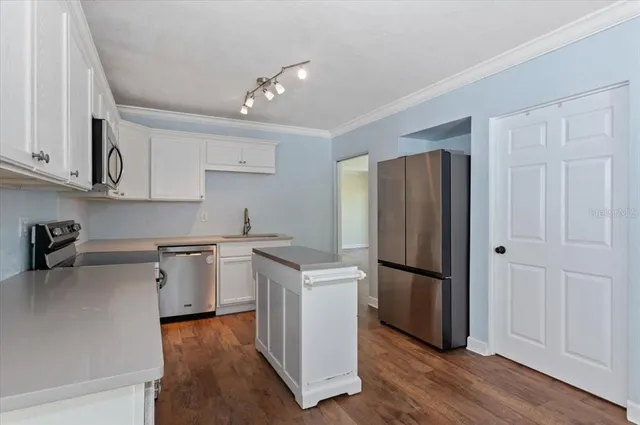 an aerial view of a house with swimming pool and a yard