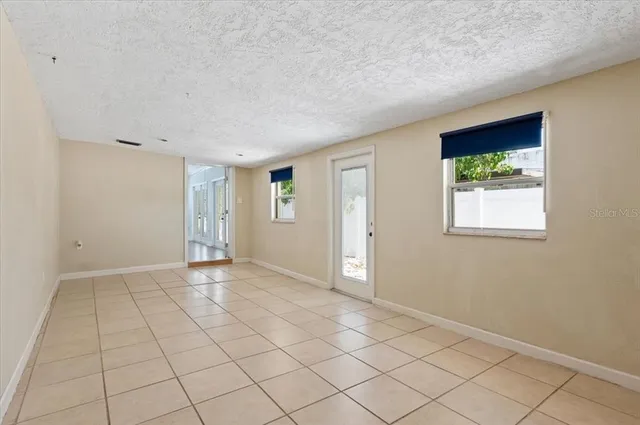 a view of a room with wooden floor and windows