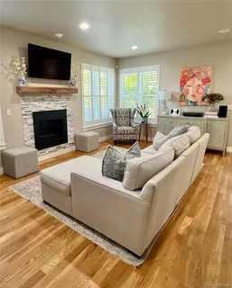 a living room with furniture fireplace and flat screen tv