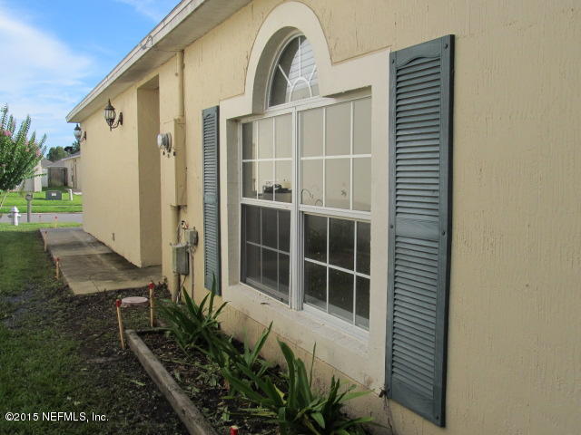 3488 Alec Drive Middleburg, FL 32068 - Photo 4 of 24 a front view of a house with a garden