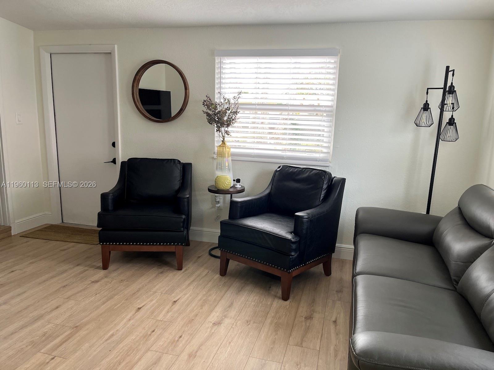 2253 Dordon Drive Melbourne, FL 32935 - Photo 12 of 40 a living room with furniture and a wooden floor