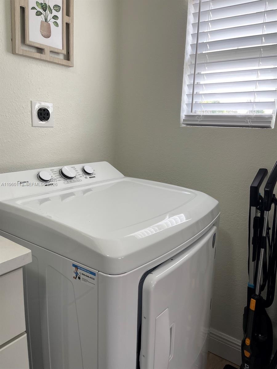 2253 Dordon Drive Melbourne, FL 32935 - Photo 16 of 40 a utility room with dryer and washer