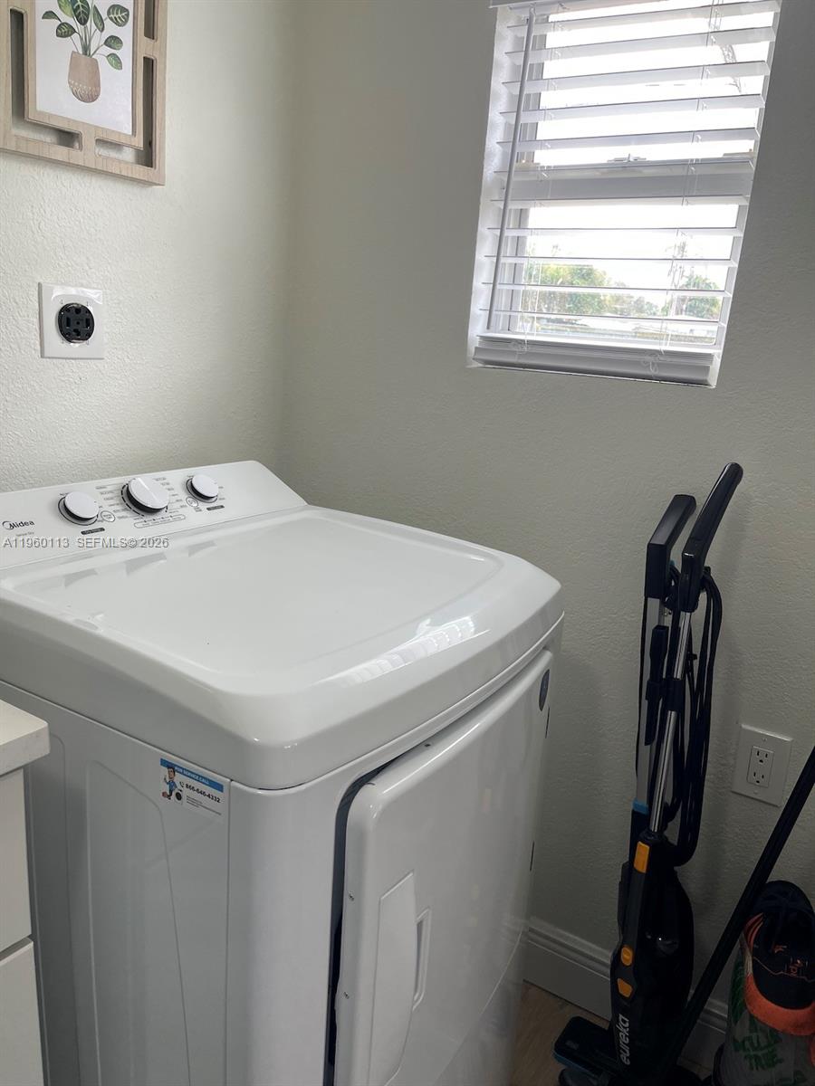 2253 Dordon Drive Melbourne, FL 32935 - Photo 17 of 40 a utility room with dryer and washer